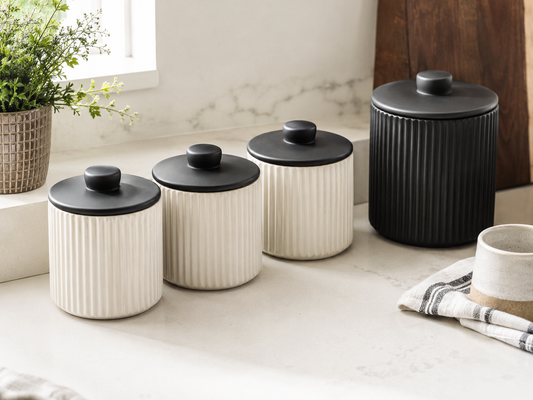A set of 3 pet treat storage canisters in black and white on a modern kitchen counter — selected by LAVORA