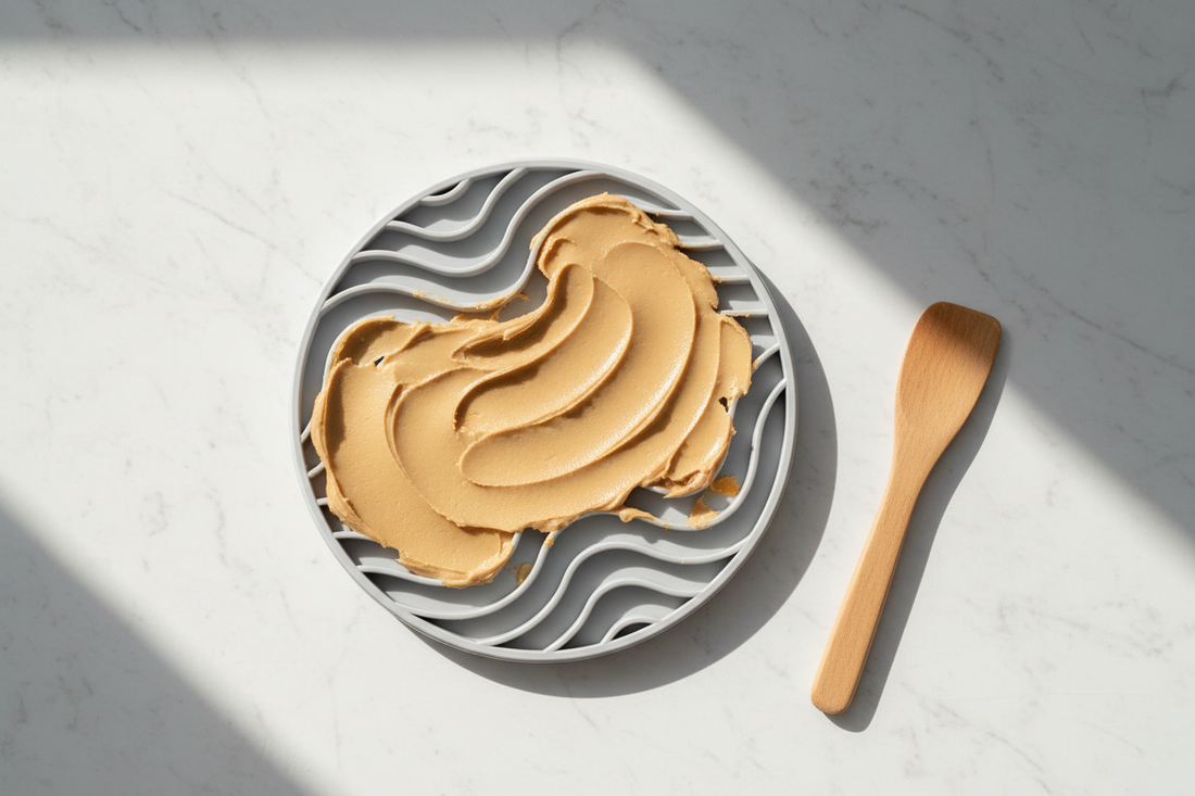 Silicone lick mat with textured grooves spread with soft food on a clean stone surface — a guide to what lick mats actually do, by LAVORA