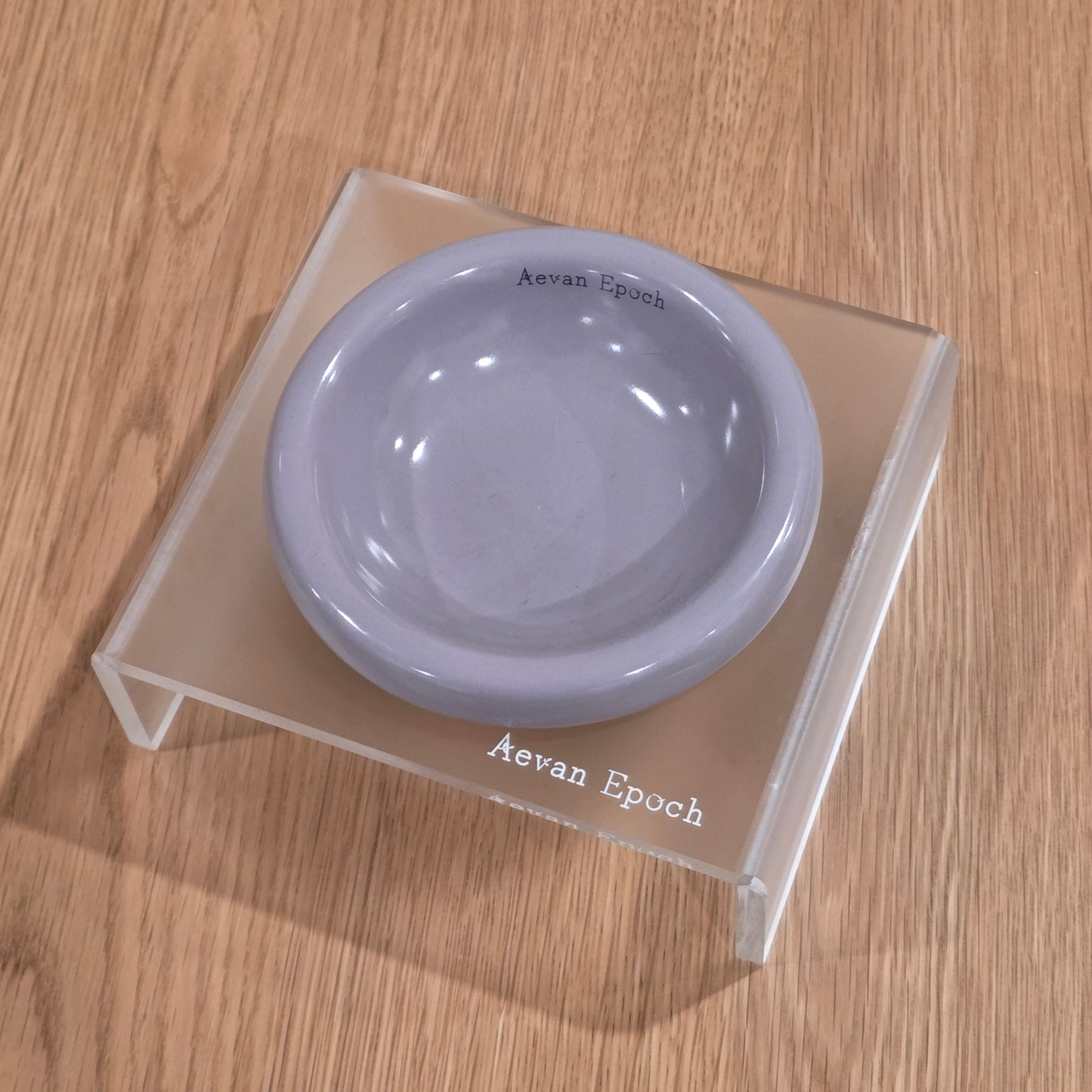 Frosted acrylic pet bowl stand with a minimalist translucent frame for modern homes