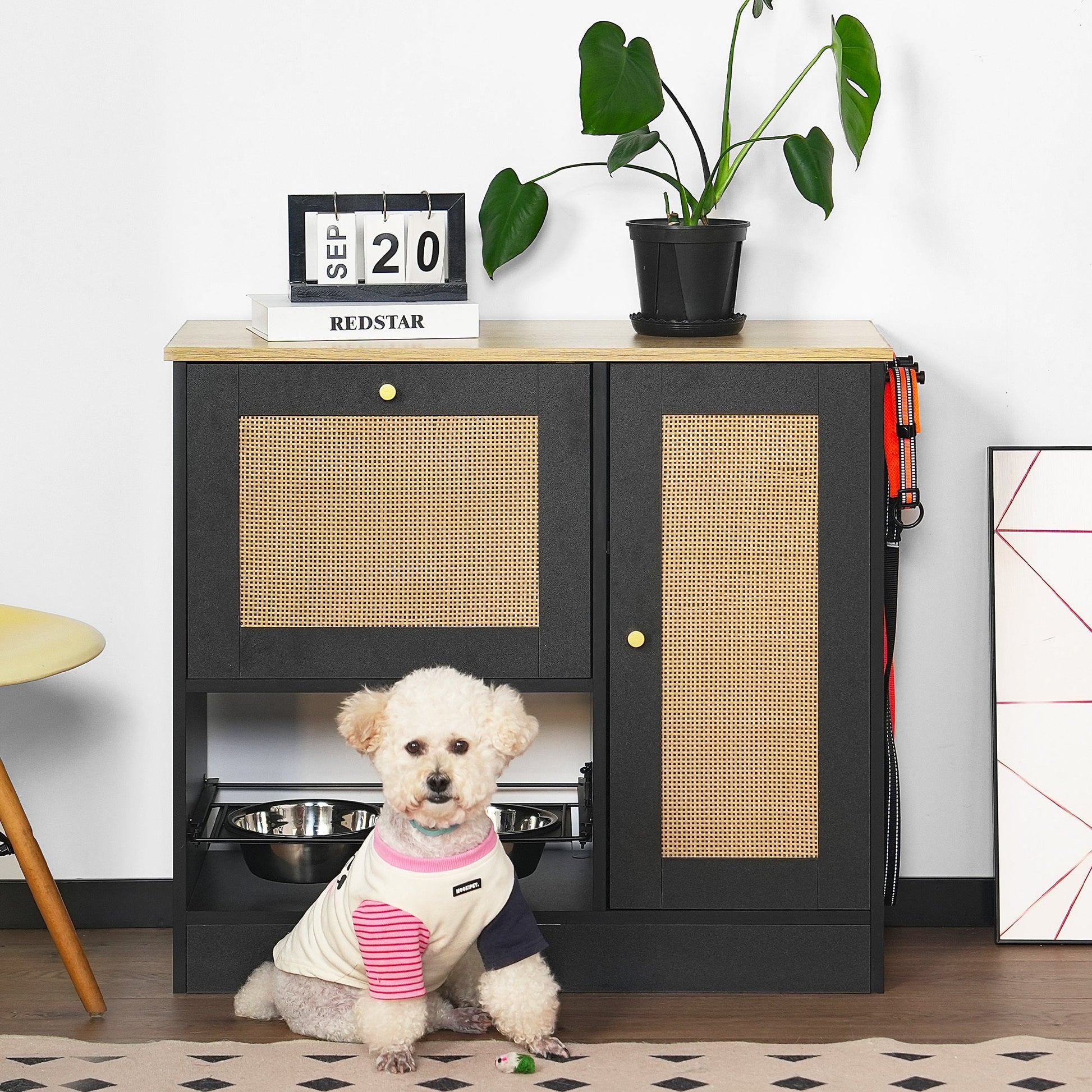 Black furniture-style pet feeding station with elevated stainless steel bowls, storage lockers, and side hooks — selected by LAVORA