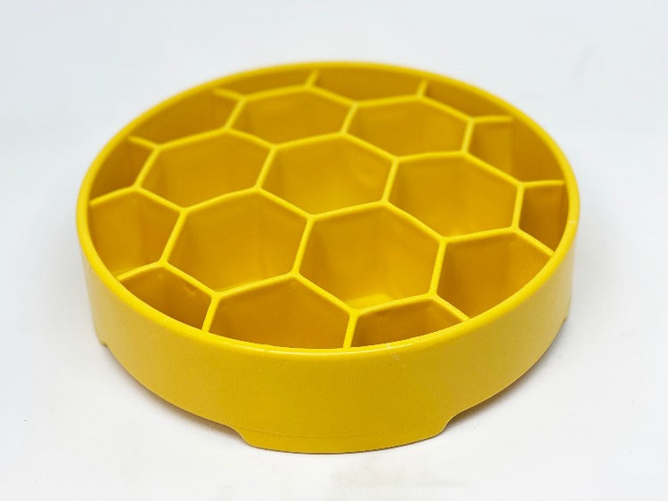 Deep-sided honeycomb dog bowl that helps keep food contained