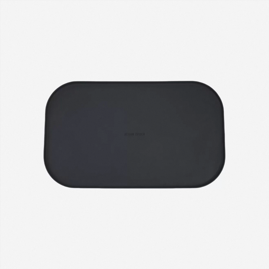 Black raised-edge silicone pet feeding mat for a modern pet feeding setup