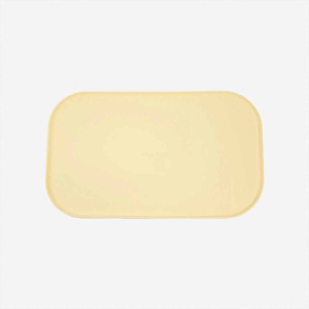 Soft yellow silicone pet feeding mat designed for a simple organized feeding area
